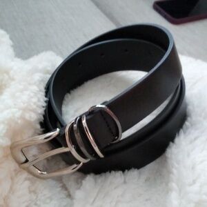 Women's black bonded leather belt. In new never used condition.